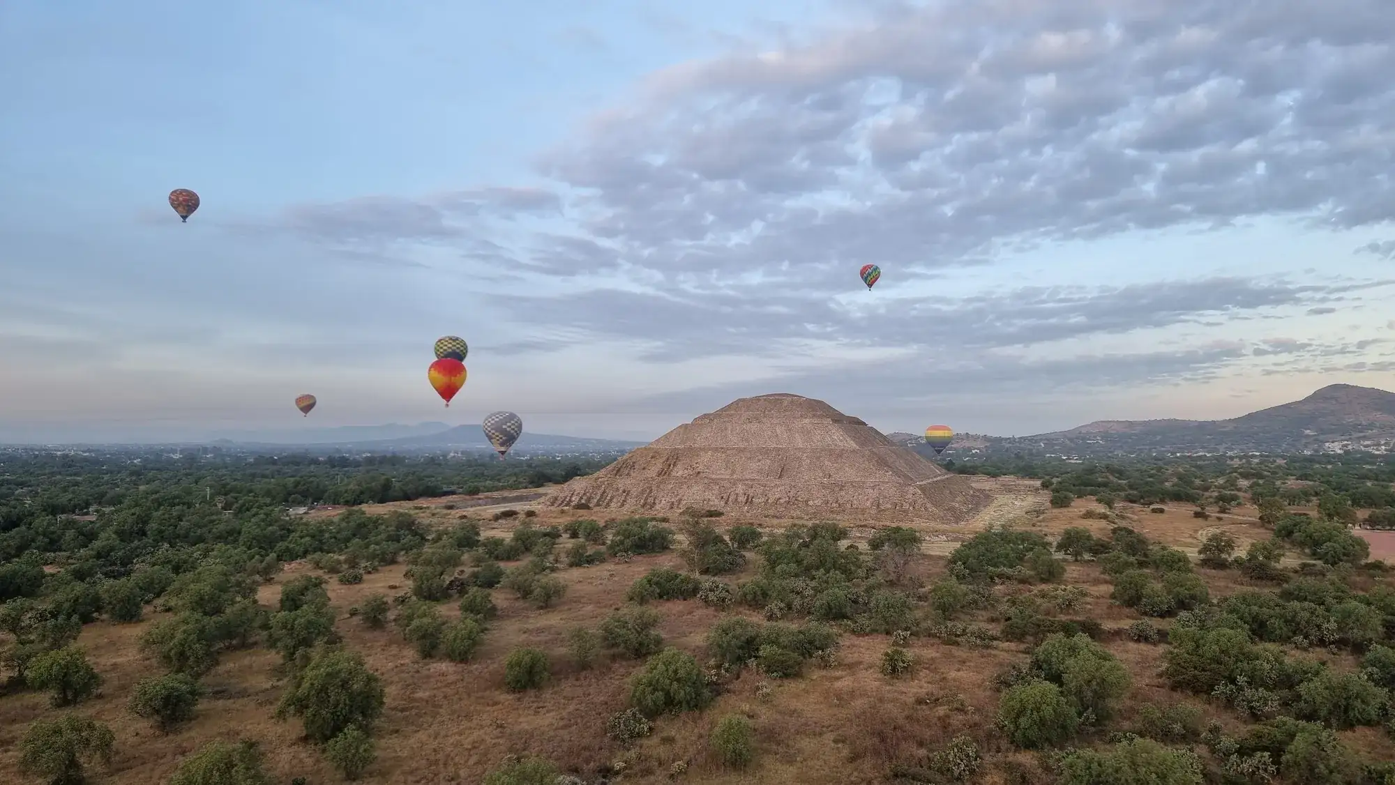 Hot air balloons over the Pyramid of the Sun at Teotihuacán, Mexico.